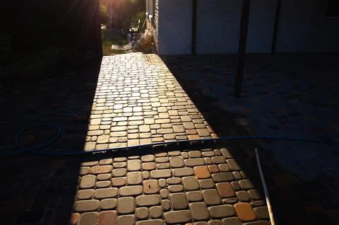 Abstract background of old cobblestone pavement close-up. Stock Photos