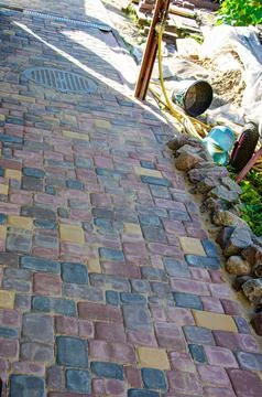 Abstract background of old cobblestone pavement close-up. Stock Photos
