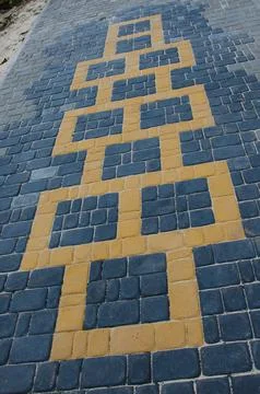 Abstract background of old cobblestone pavement close-up. Stock Photos