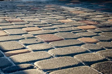 Abstract background of old cobblestone pavement close-up. Stock Photos