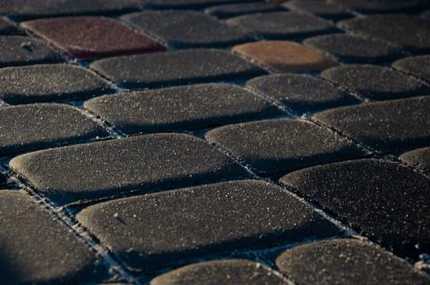 Abstract background of old cobblestone pavement close-up. Stock Photos