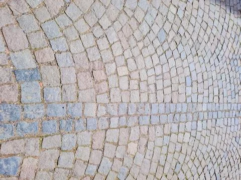Abstract background. Old cobblestone pavement close-up. Stock Photos