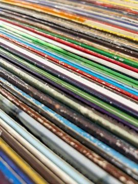 Abstract background with old vinyl record covers in second hand music store Stock Photos
