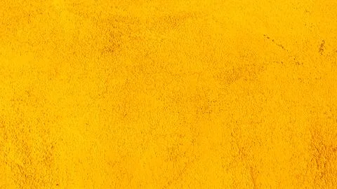 Abstract background of old yellow plaster on the wall. Stock Photos