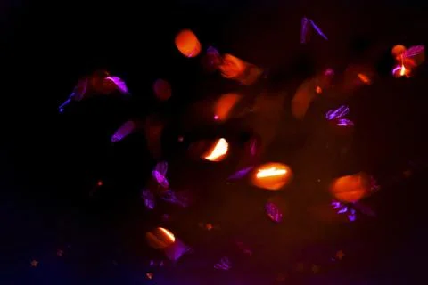 Abstract background, overlay of sparkling confetti in motion on black background Stock Photos