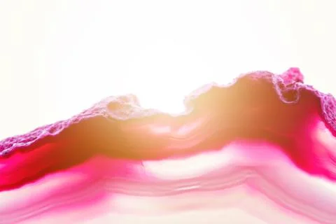 Abstract background, pink agate slice mineral cross section with sunbeam isol Stock Photos