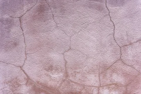Abstract background of pink textured plaster with cracks 库存照片