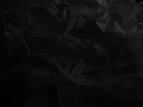 Abstract background plastic bag black vacuum cling foil wrinkle texture Stock Photos