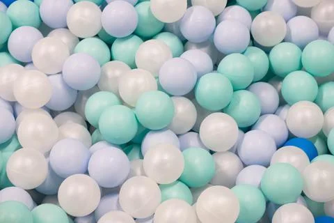 Abstract background from plastic balls of white, blue and green colors Stock Photos