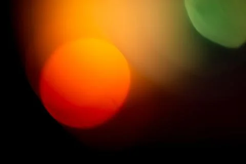 Abstract background presenting soft, out of focus light with warm orange, red Stock Photos