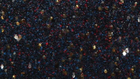 Abstract Background Red and Blue Droplets and Gold Flakes Slowly Float in Space Stock Footage 71121861