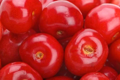 Abstract background: Red cherries without stalks. Closeup. Focused on two ber Stock Photos
