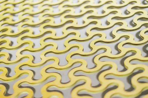 Abstract background, a repeating pattern of gold curved round cells in a gold Stock Photos