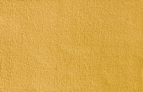 Abstract background of rough yellow plaster. Stock Photos