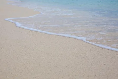 Abstract background of sandy beach with soft waves. Stock Photos