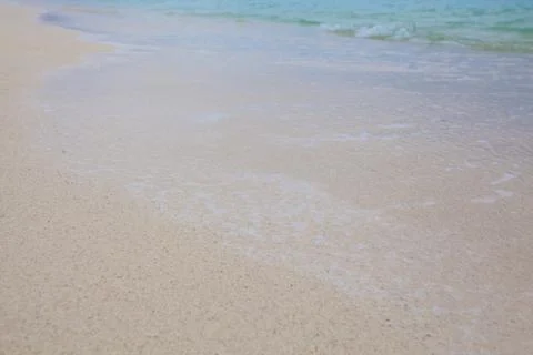 Abstract background of sandy beach with soft waves. Stock Photos