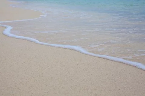 Abstract background of sandy beach with soft waves. Stock Photos