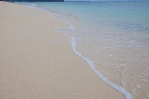 Abstract background of sandy beach with soft waves. Stock Photos