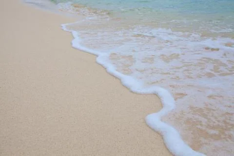Abstract background of sandy beach with soft waves. Stock Photos