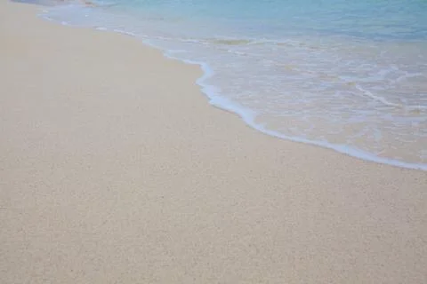Abstract background of sandy beach with soft waves. Stock Photos