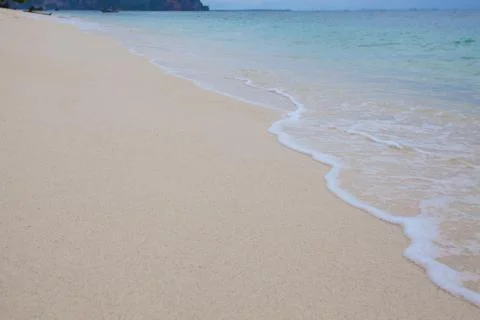 Abstract background of sandy beach with soft waves. Stock Photos