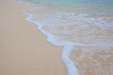 Abstract background of sandy beach with soft waves. Stock Photos