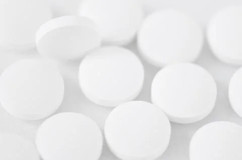 Abstract background - a scattering of white tablets Stock Photos