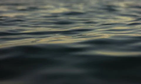 An abstract background of seawater flow under light exposure 库存照片
