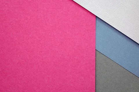 Abstract background from sheets of grey, pink and blue paper. Foto stock