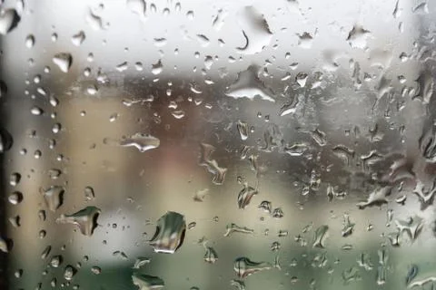 Abstract background showing a window with raindrops rolling off blue toned Stock Photos