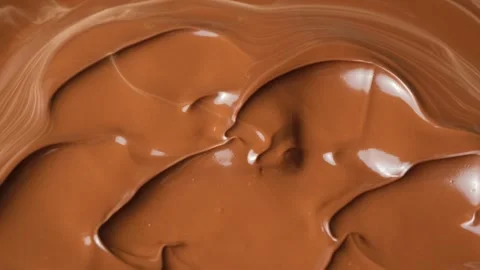 Abstract background of silky milk chocolate waves expanding for sweet dessert ba Stock Footage 344871688