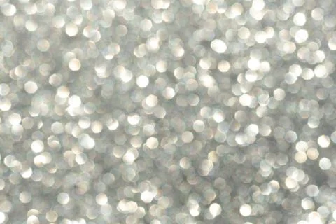 Abstract background of silver bokeh, defocused blurry sparkles. Stock Photos