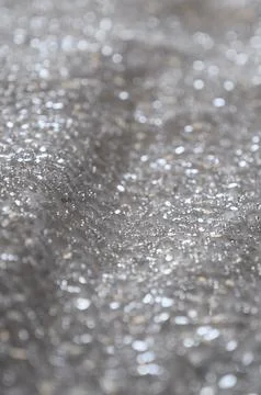 Abstract background of silver sequins. Stock Photos
