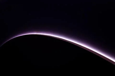 Abstract background with a soft violet glowing curve on dark surface. Minimal Stock Illustration