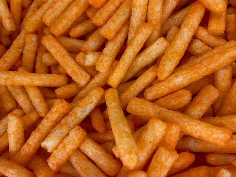 Abstract background of spicy snacks in the shape of long squares Foto stock