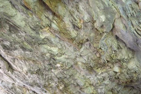 Abstract background. Stone formation of a sheer cliff close-up. Stock Photos