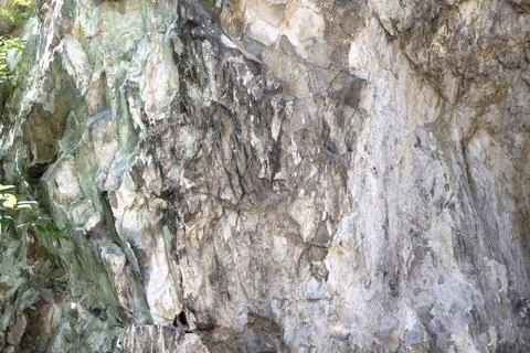 Abstract background. Stone formation of a sheer cliff close-up. Stock Photos