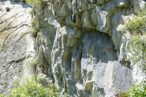 Abstract background. Stone formation of a sheer cliff close-up. Stock Photos