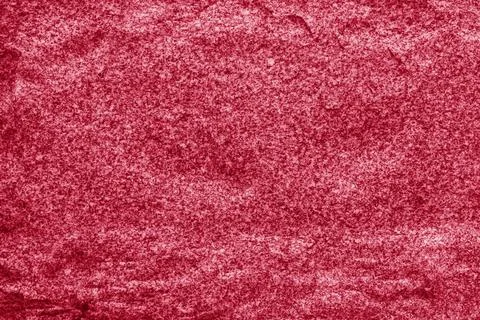 Abstract background from the surface of a large stone painted with red paint. Stock Photos