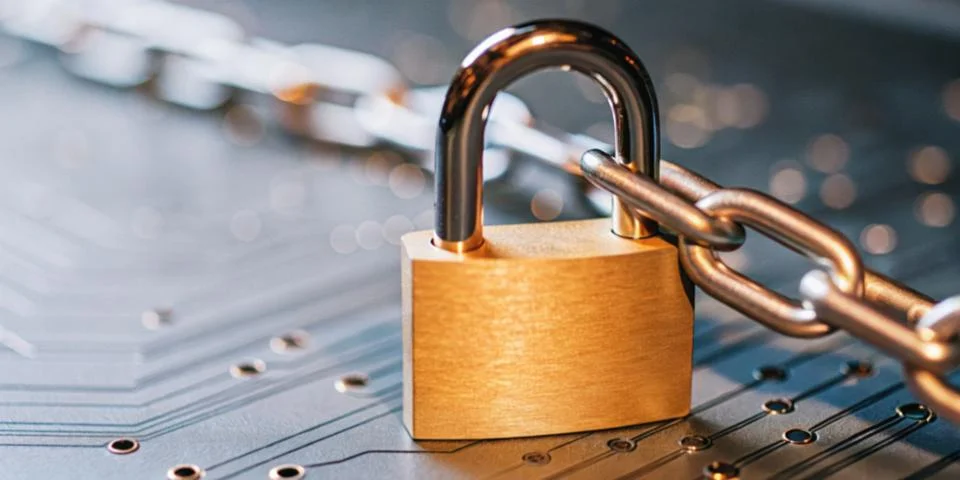 Abstract background in technology. Close-up of a padlock on a circuit board Stock Photos