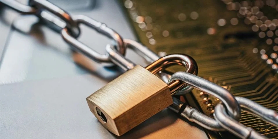 Abstract background in technology. Padlock and chains on the circuit board Stock Photos