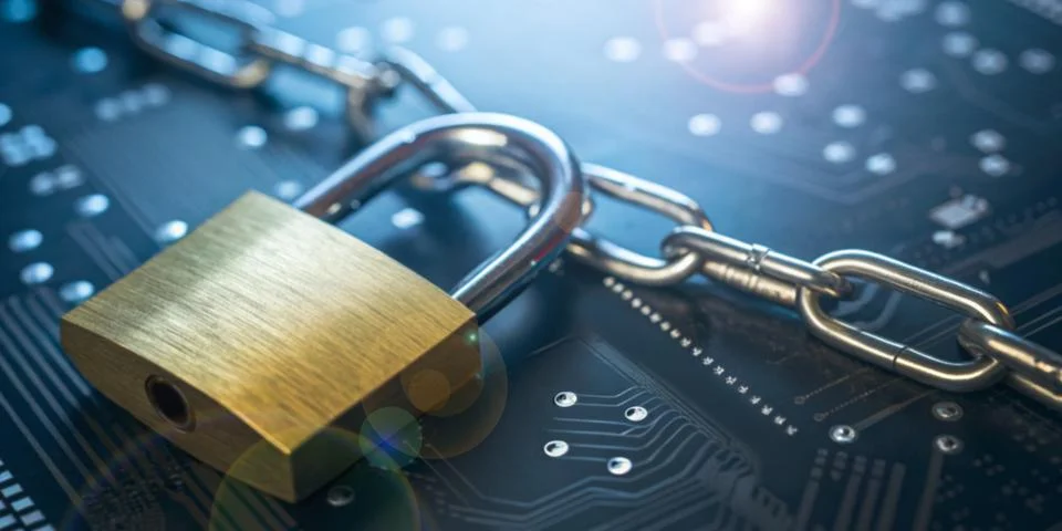 Abstract background in technology. Padlock and chain are laid on circuit board Stock Photos