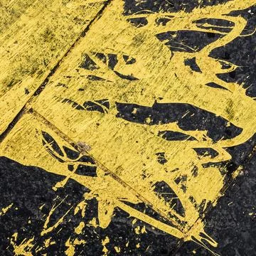 Abstract Background Tecture Of Yellow Paint Spilled On Black Tarmac Stock Photos