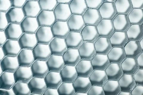 Abstract background texture featuring a metallic blue honeycomb grid struct.. Stock Photos
