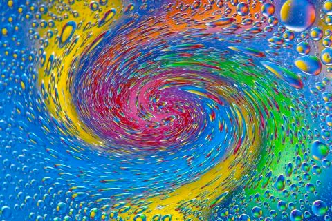 Abstract background texture in the form of blurred twisted color round spots Stock Illustration
