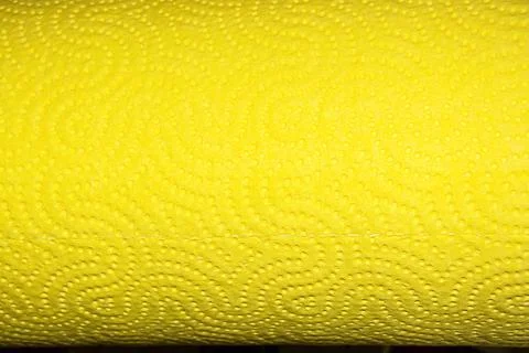 Abstract background texture of perforated paper in yellow color. Copy space. Stock Photos