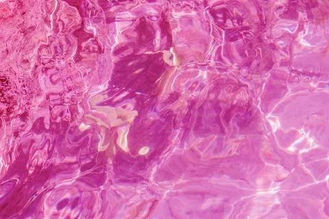 Abstract background texture of wavy transparent pool water illuminated with.. Stock Photos