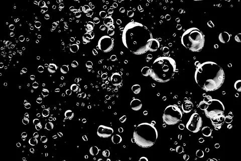 Abstract background of various sized bubbles on a black background. Perfect.. Stock Photos