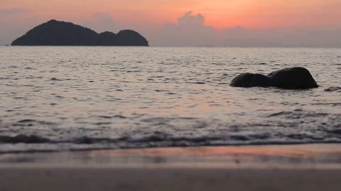 Abstract background video. Close-up of waves at the beach at the sunset time. Stock Footage 99892560