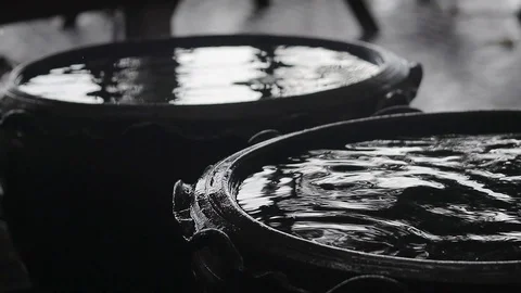 Abstract background video. Raindrops are falling into the jug with water. Stock Footage 99892690